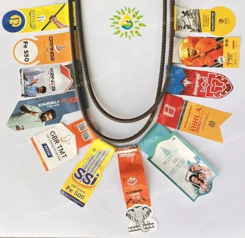 Multicolour bundle tags fanned in a U around a bent steel bar, on white